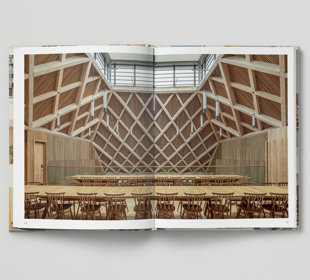 Open book showing an interior design of a modern building with wooden ceiling and tables.