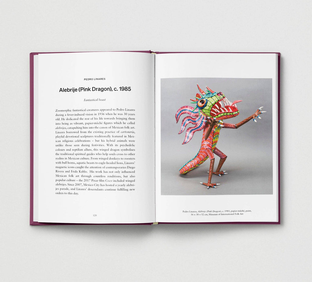 Open book showing a colorful alebrije sculpture on a gray background