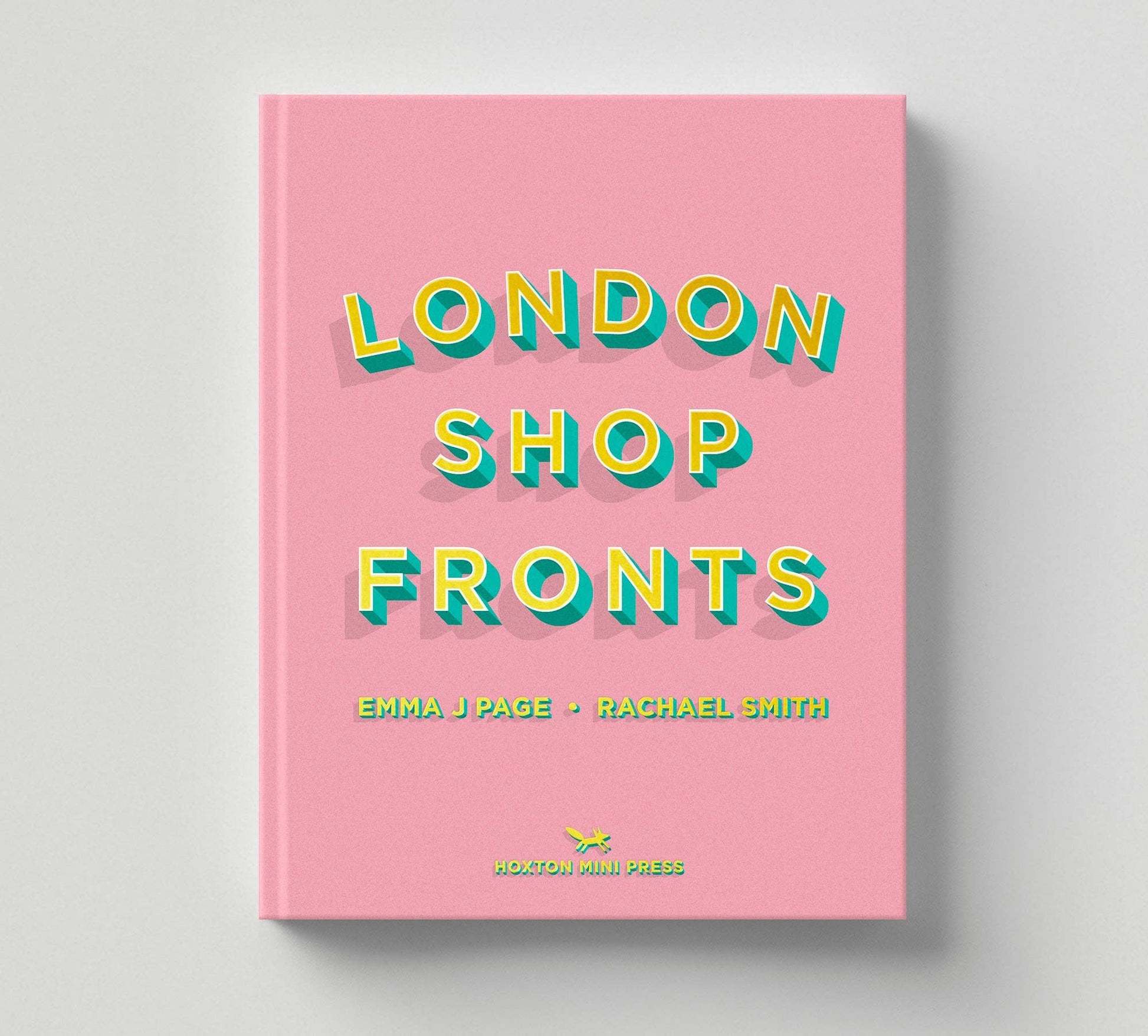 Book titled 'London Shop Fronts' with colorful text on a pink cover against a gray background
