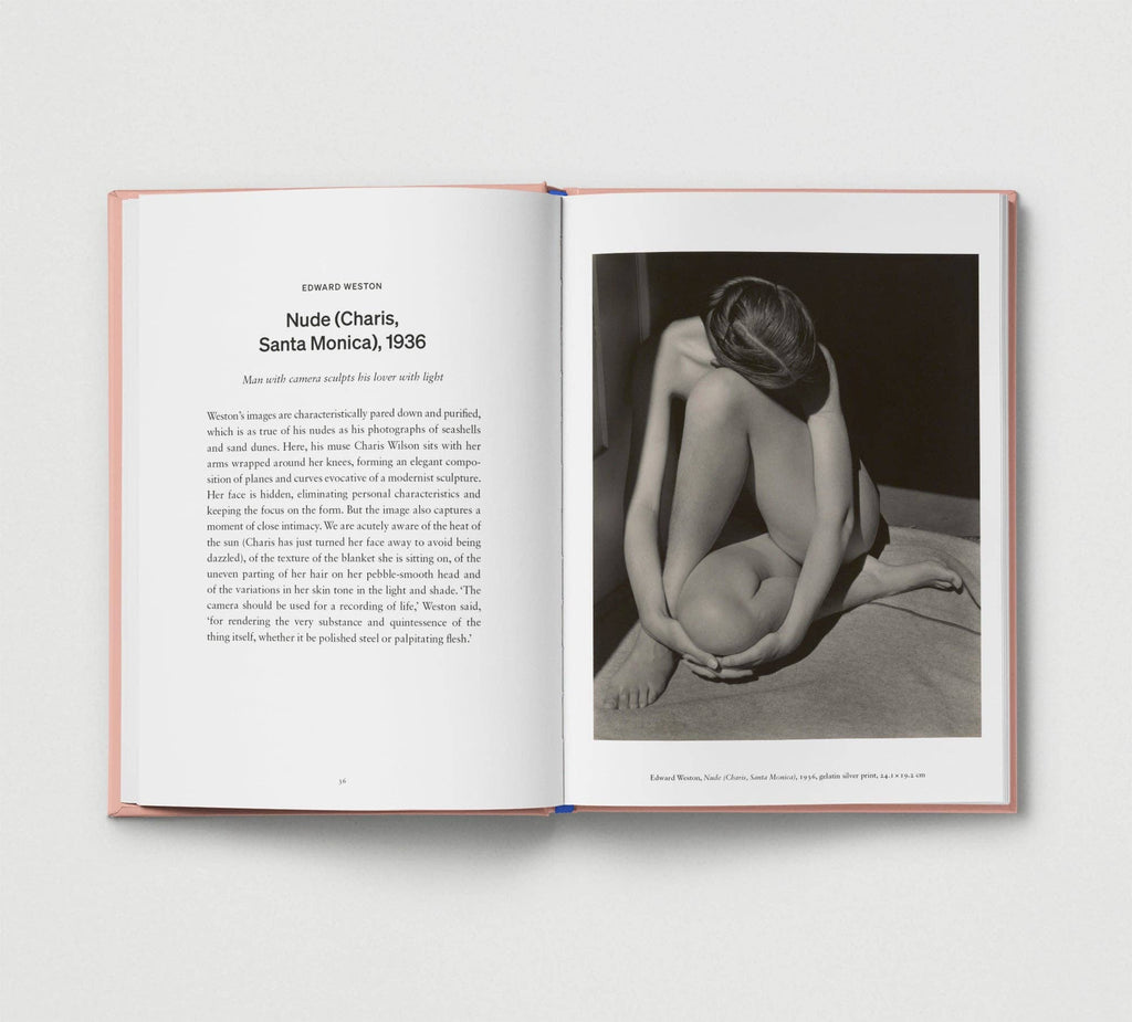 Open book with a black and white photograph of a nude figure on a light gray background