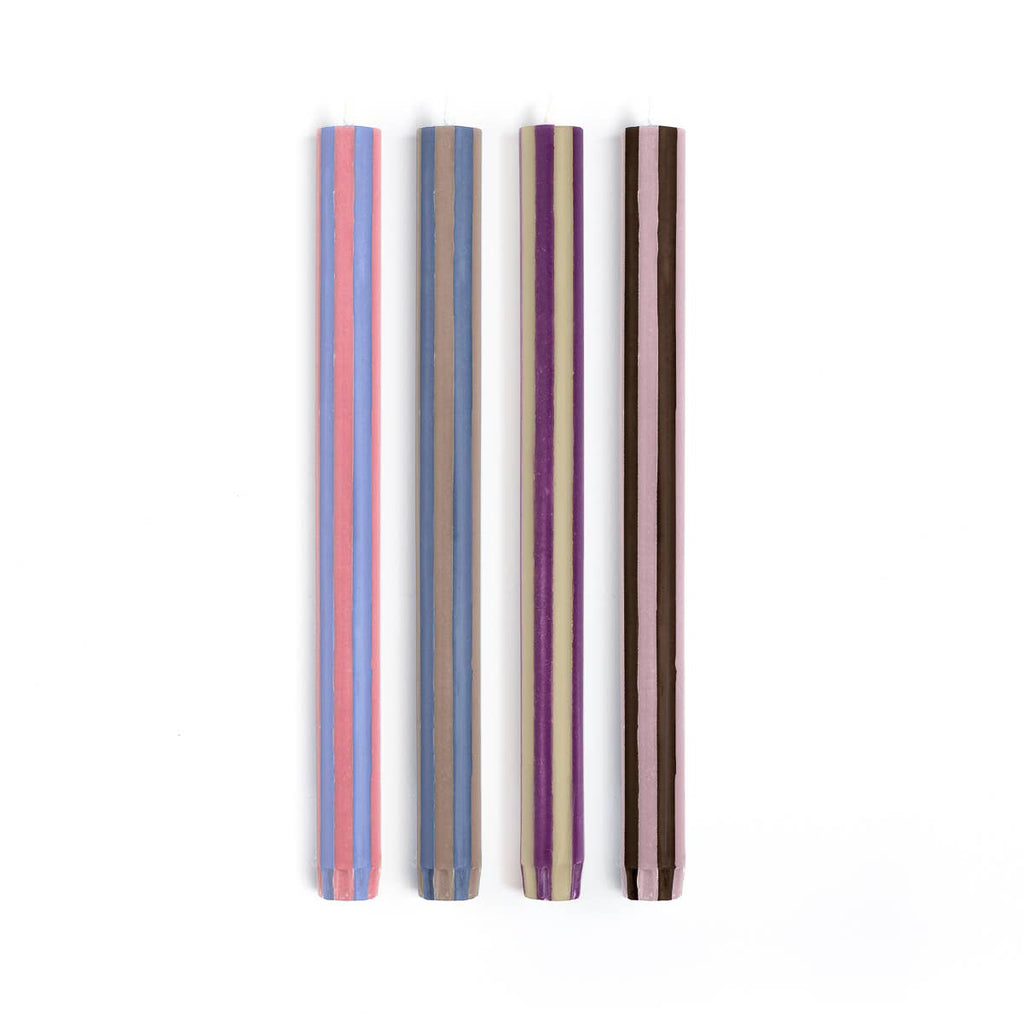 Four striped straws in different colors on a white background