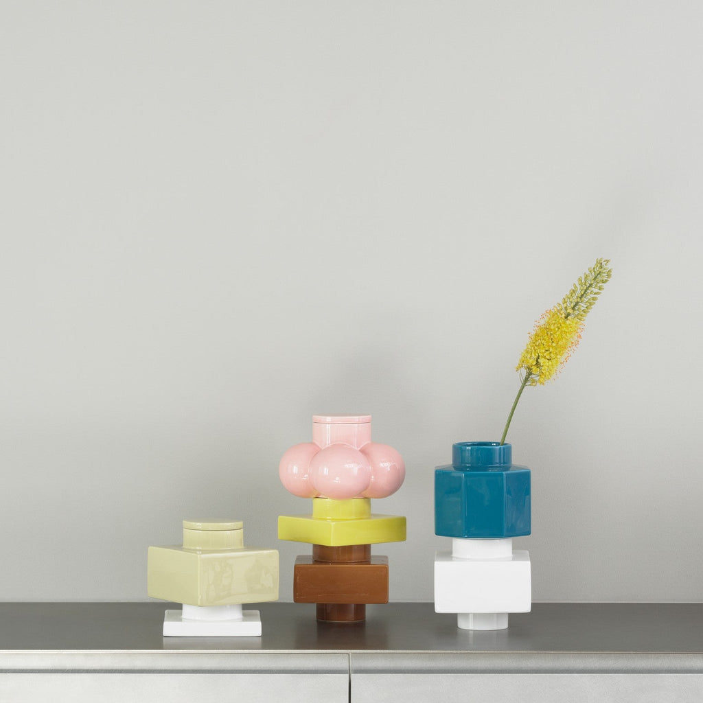 Set of colorful geometric vases on a gray surface with a neutral background