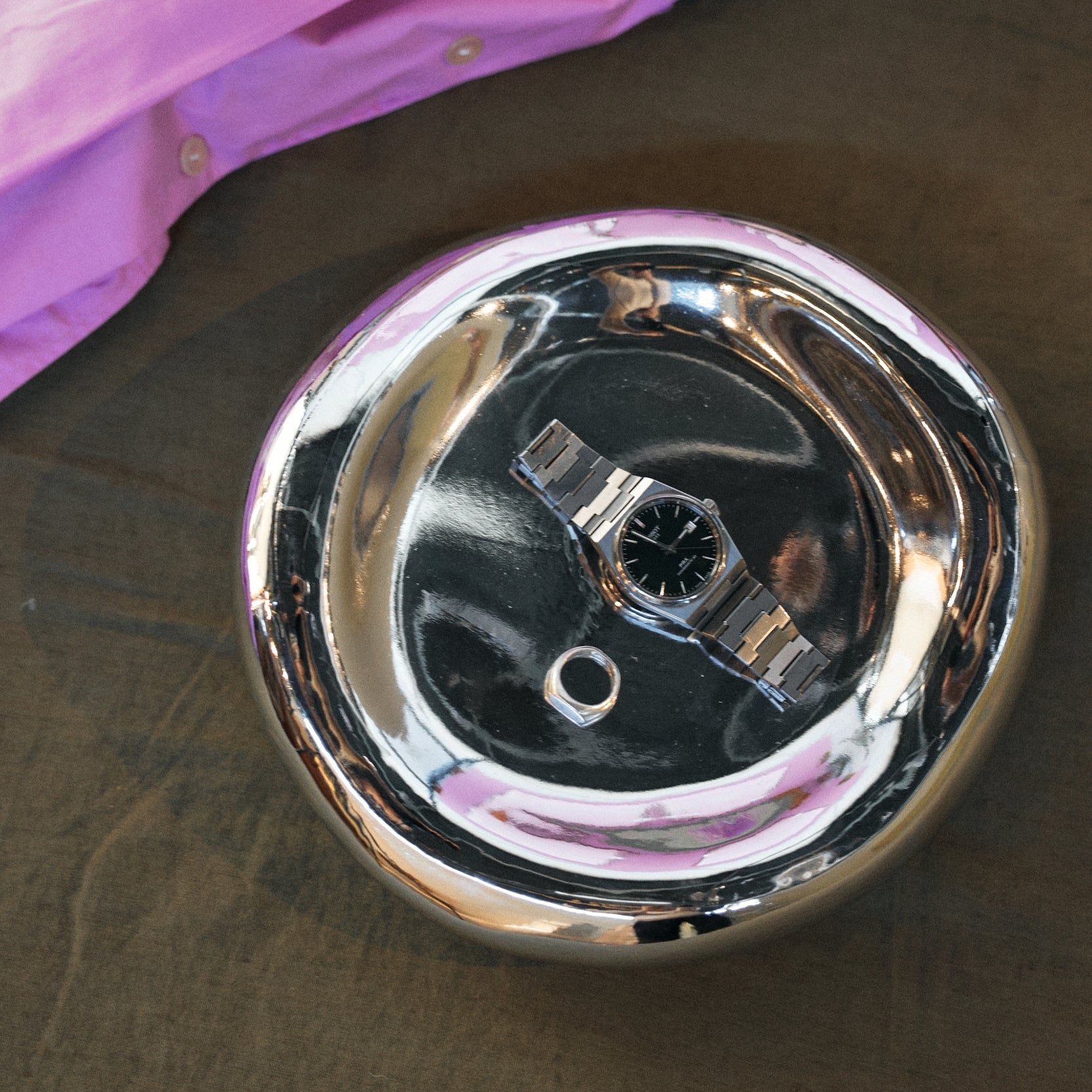 Chrome bowl on linen background