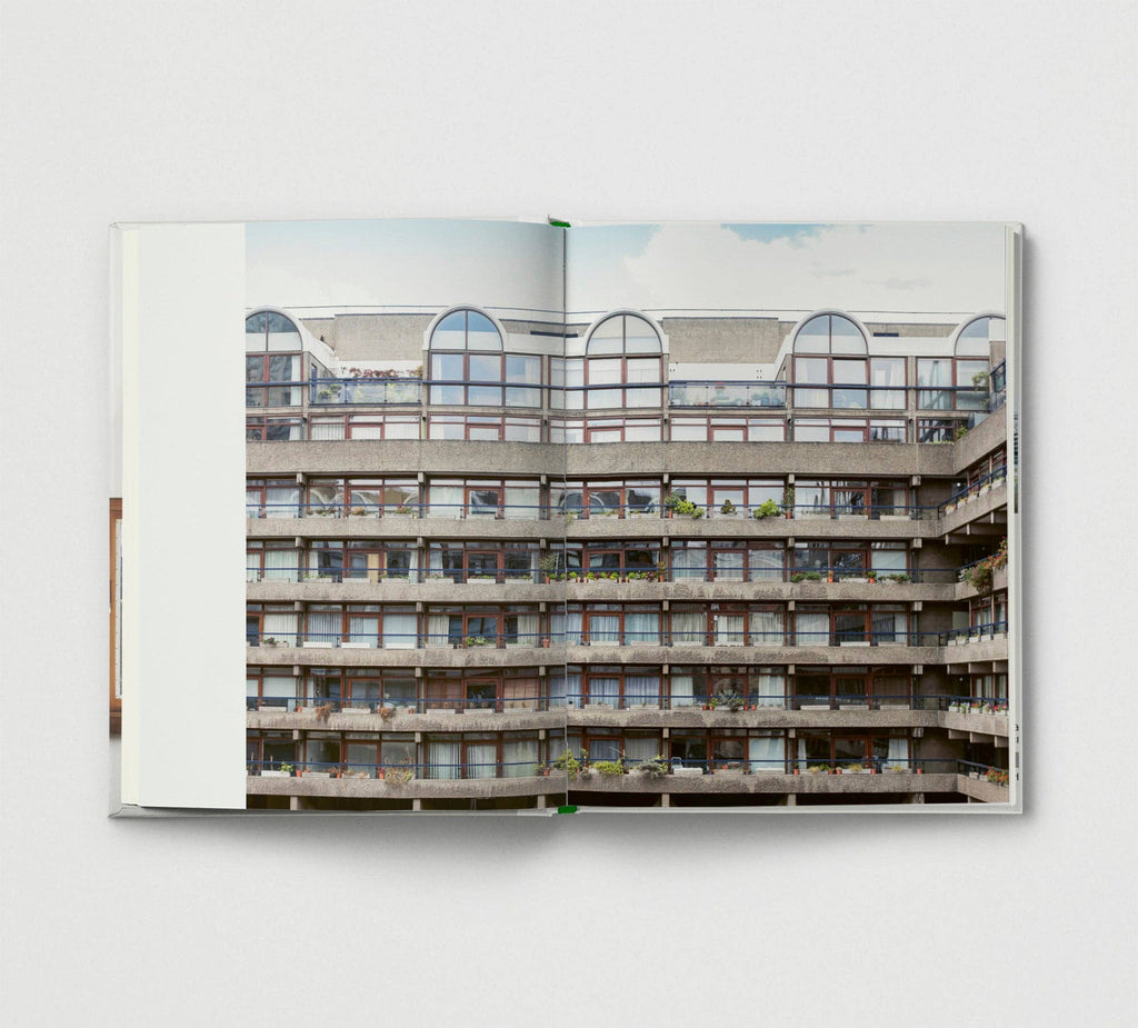 Open book showing a photograph of a multi-story building with balconies.