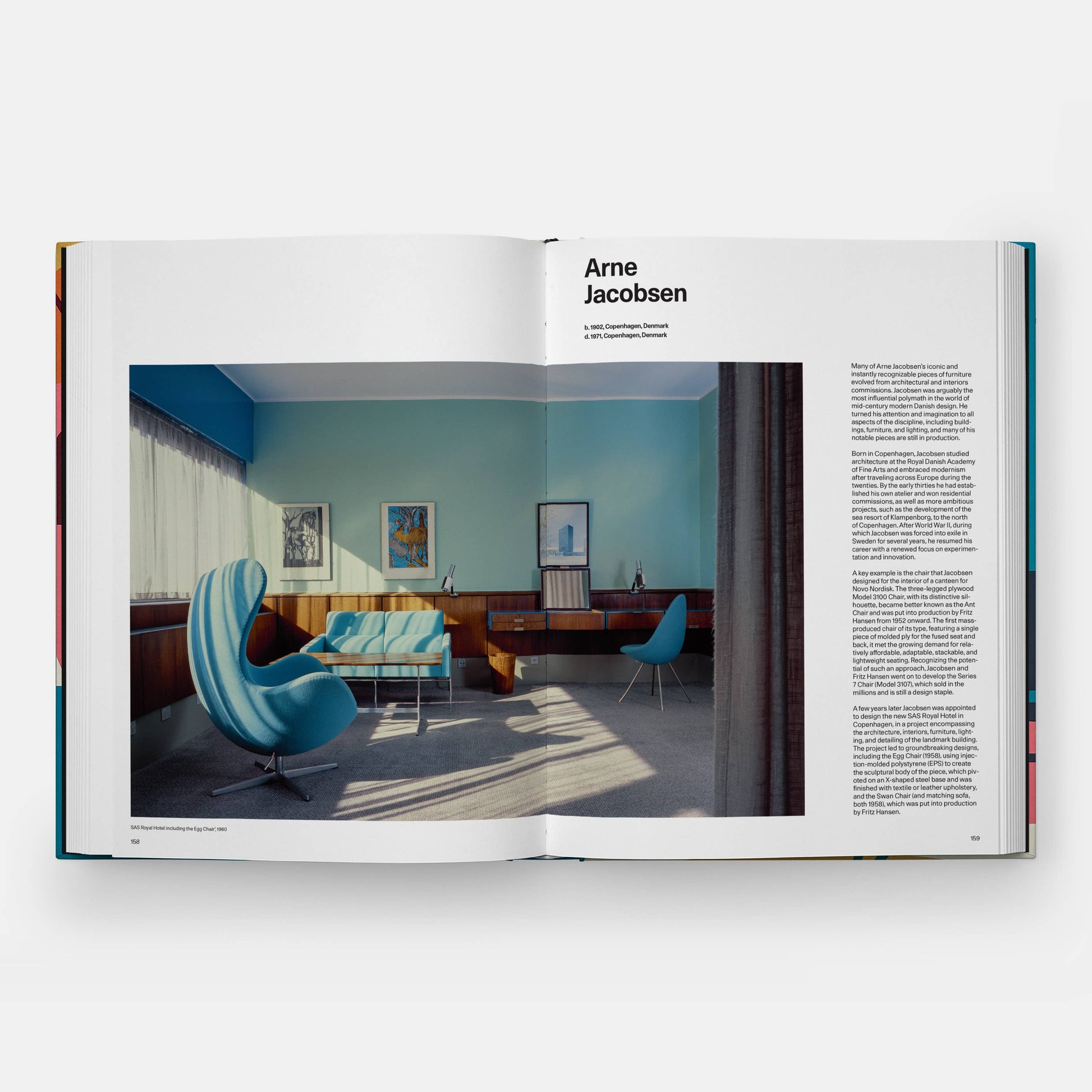 Open book showing a room with modern furniture and decor, featuring the name Arne Jacobsen.