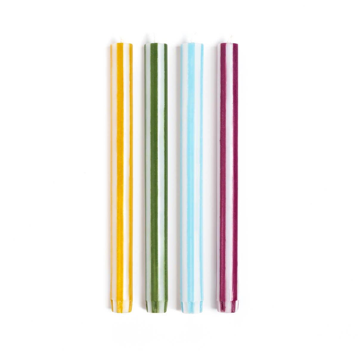 Multi coloured striped candles on a white background