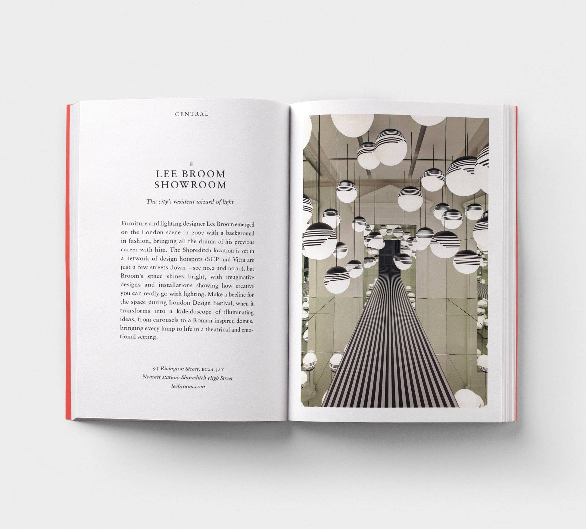 Open book showing interior design layout with text and image of a showroom.