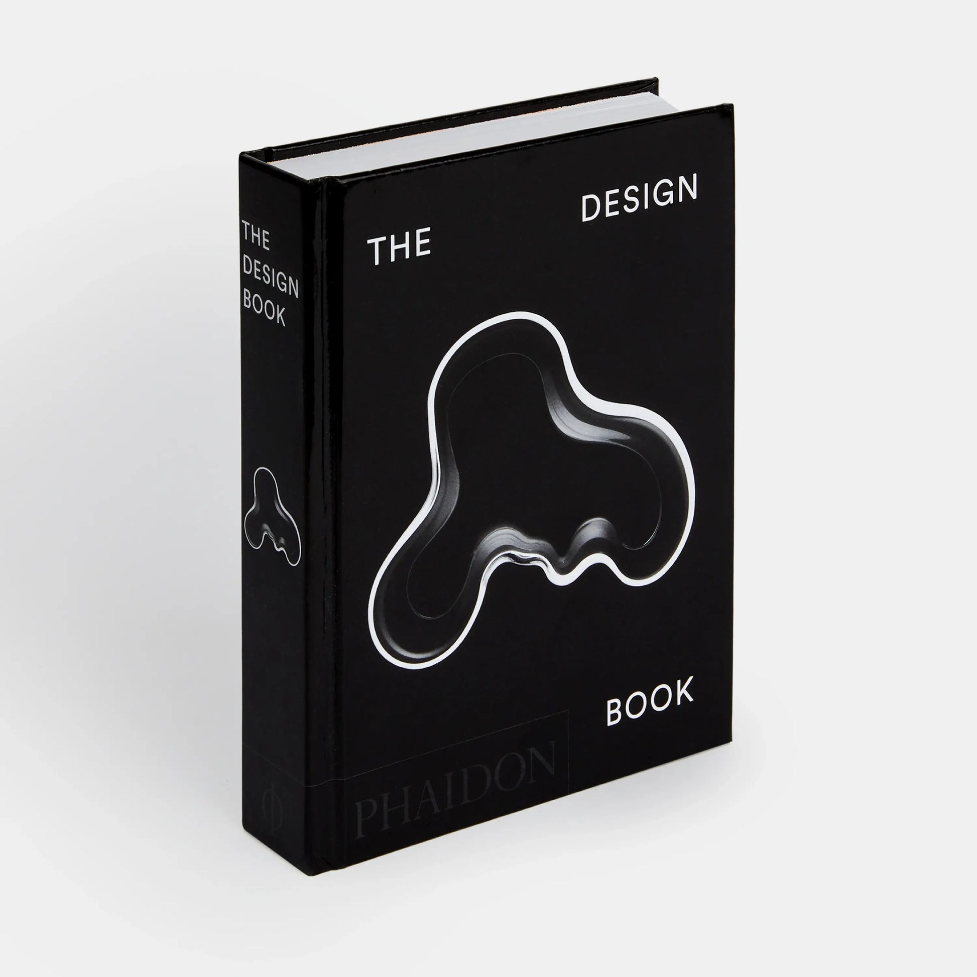 Black book titled 'The Design Book' by Phaidon on a white background