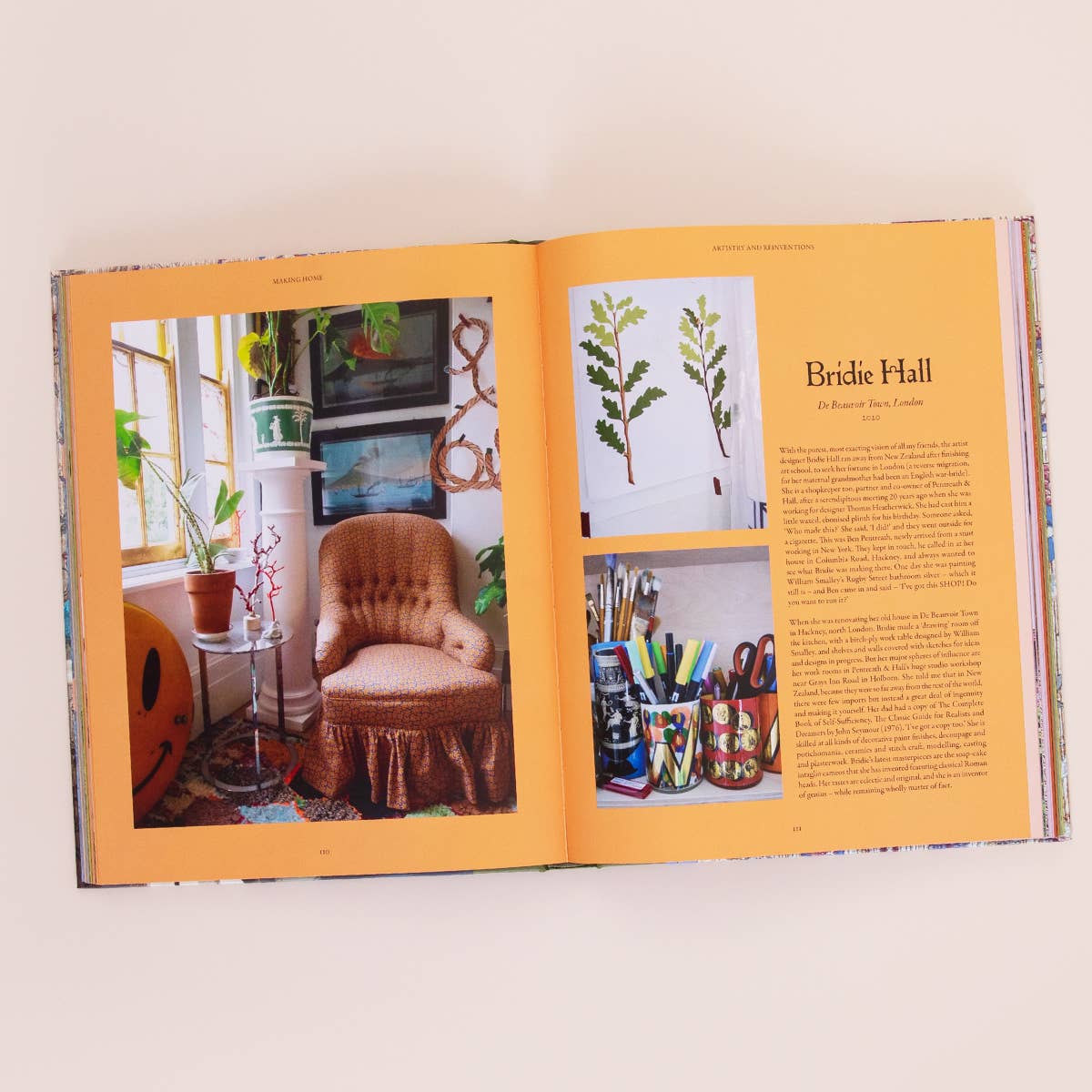 Open book with interior design images and text on a white background