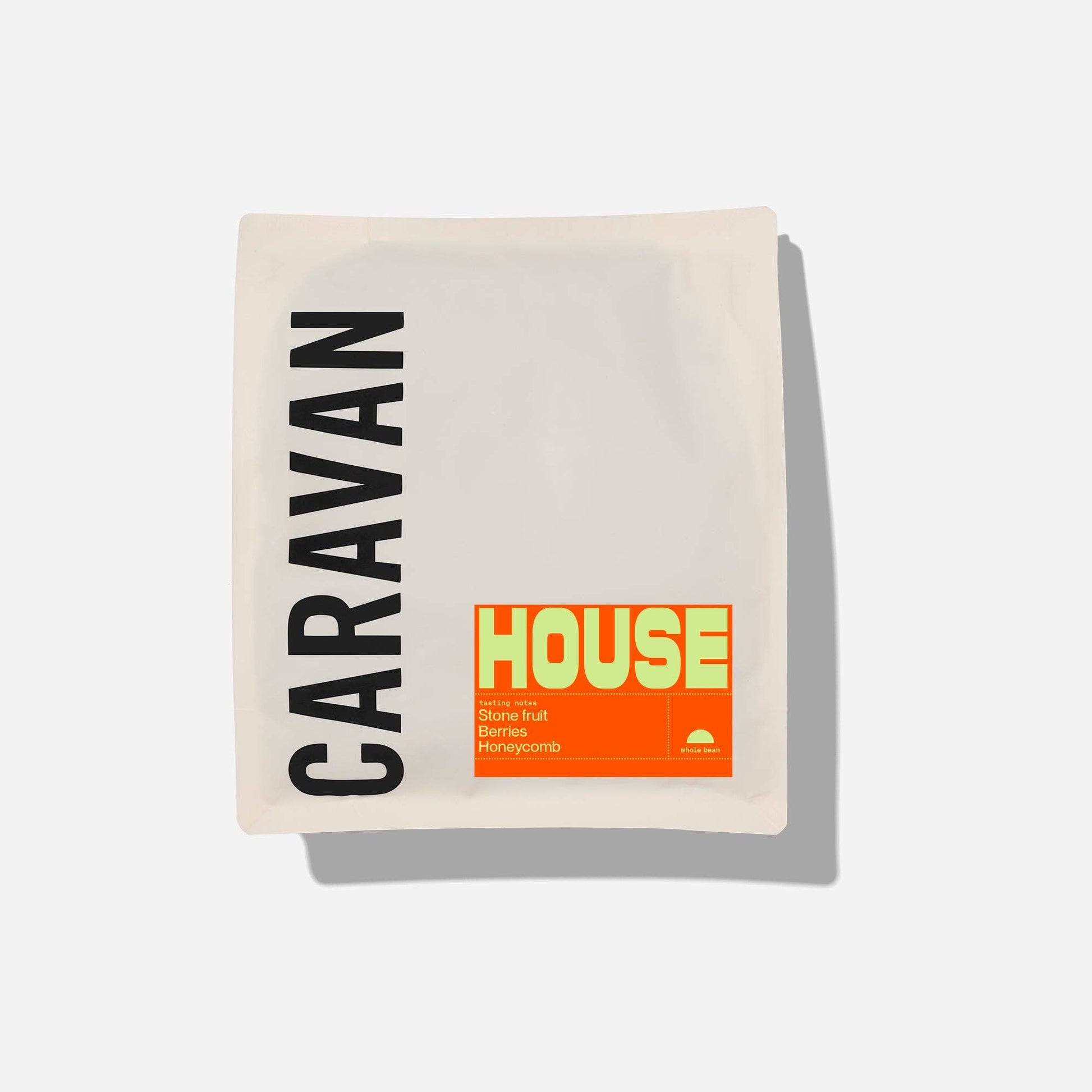 A square cream-colored Caravan House camping tent or hammock package, featuring the brand name 'CARAVAN' in black vertical text and a bright orange and yellow 'HOUSE' label, shown on a light gray background with a soft drop shadow.