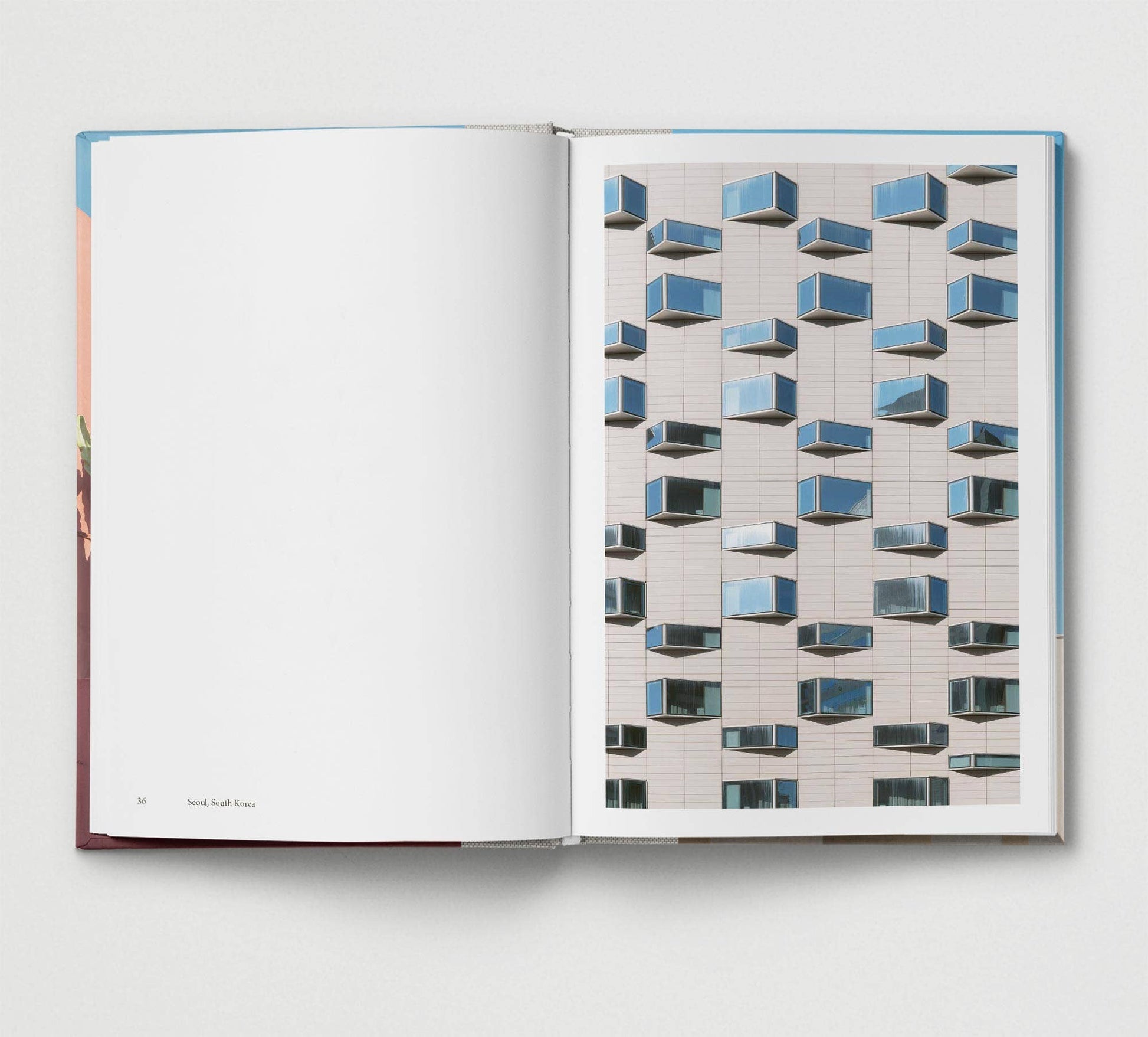 Open book showing a page with a geometric pattern of blue and gray boxes on a white background