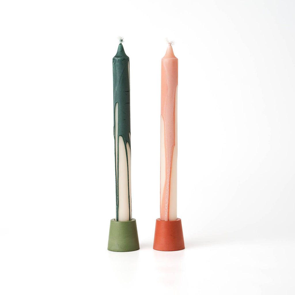 Green & orange candle on white background