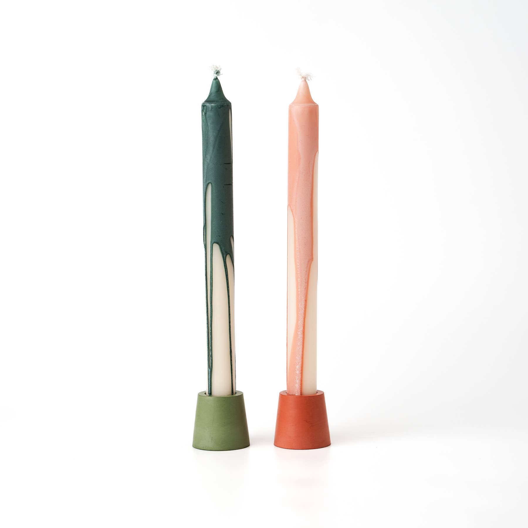 Green & orange candle on white background