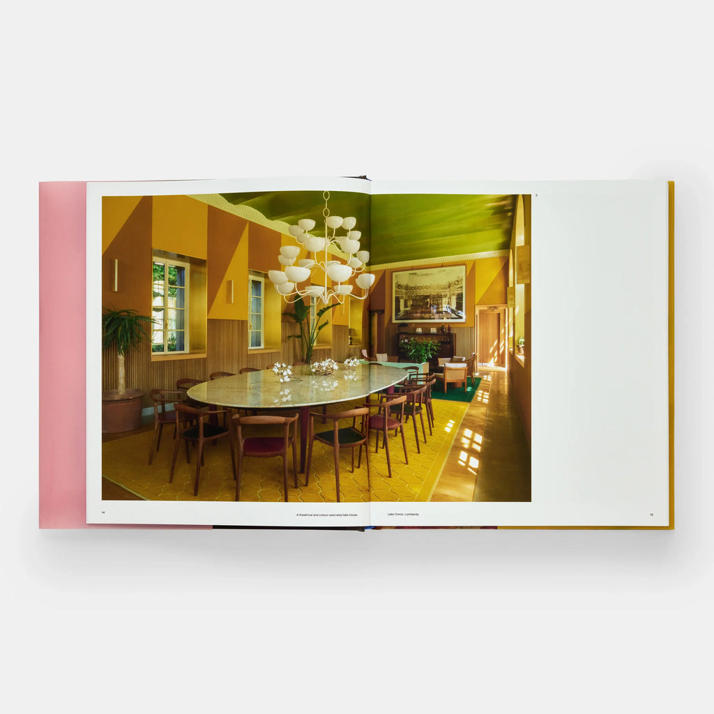 Open book showing a dining room with a table and chairs, and a chandelier.
