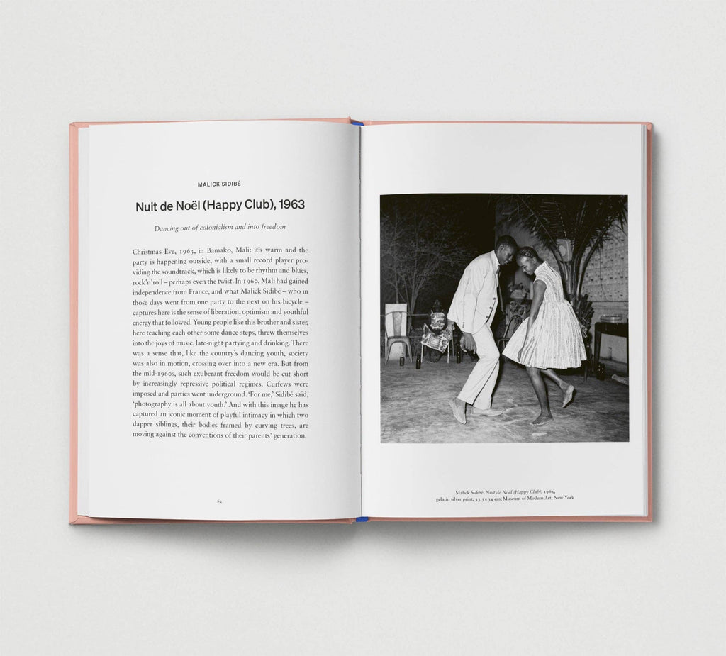 Open book showing a black and white photograph of two people dancing in a club.