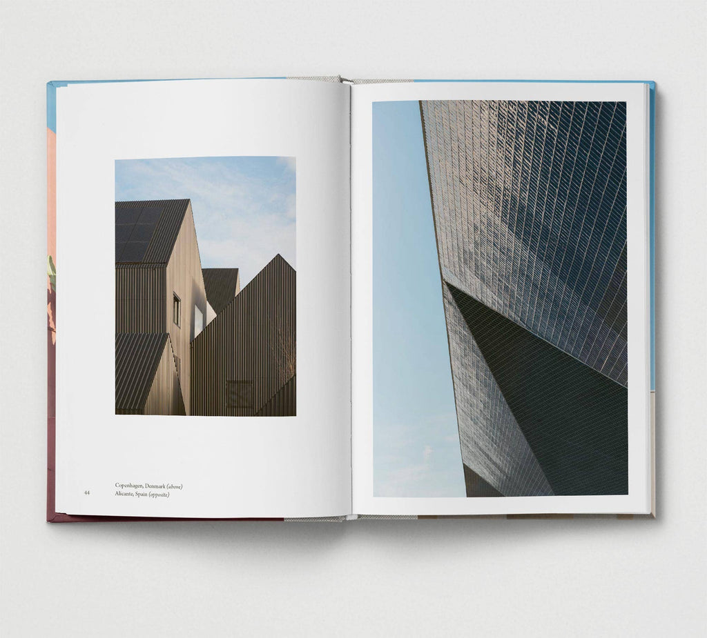 Open book showing architectural images of modern buildings.