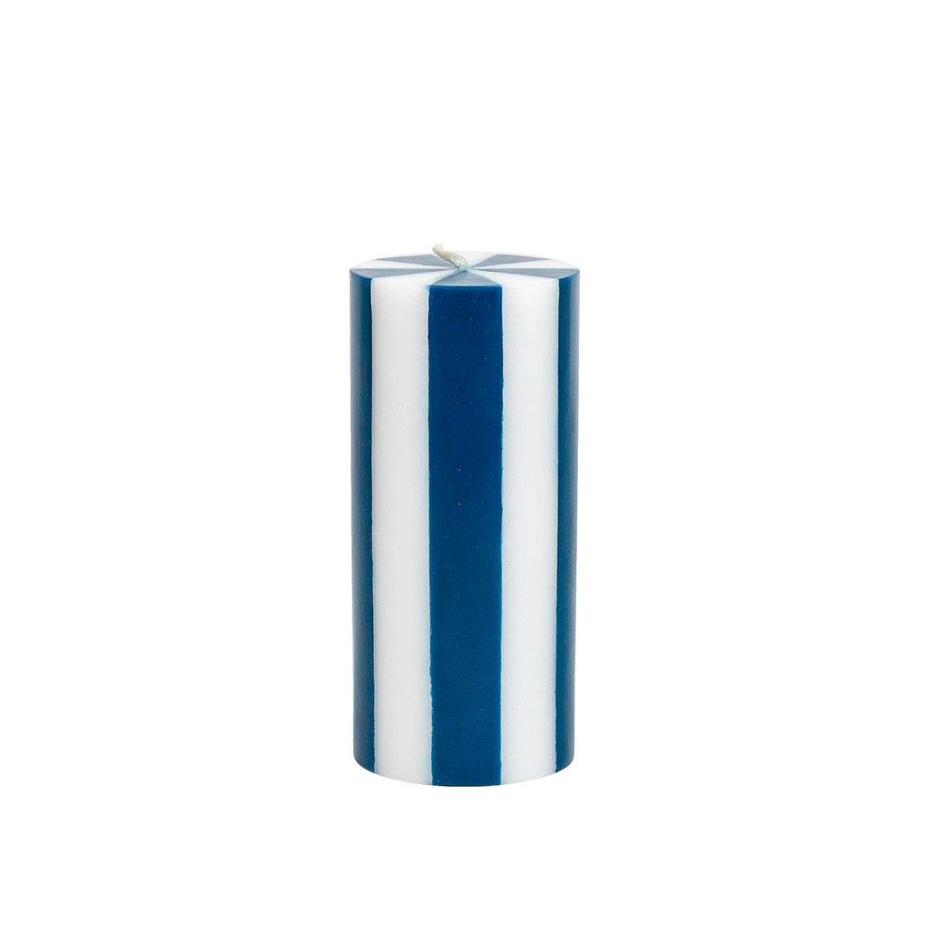 Striped blue pillar candle on white background