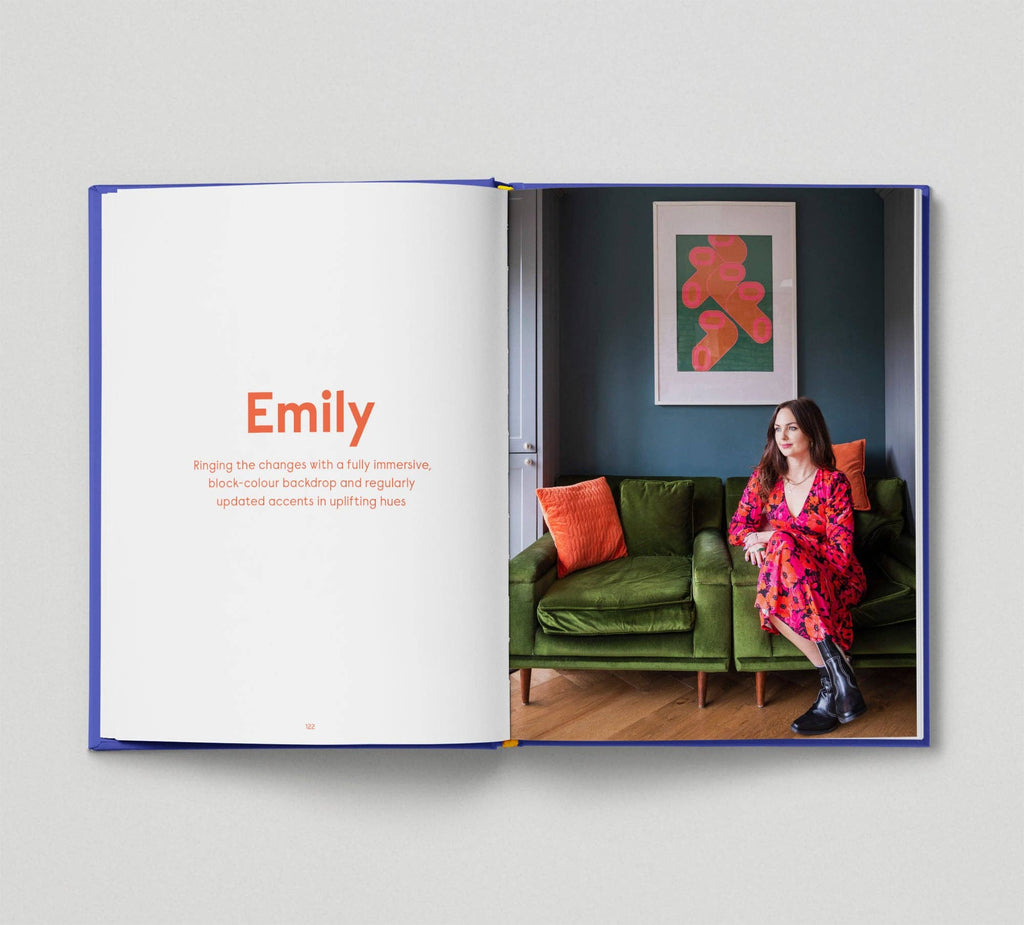 Open book showing a woman sitting on a green couch with a colorful painting in the background.