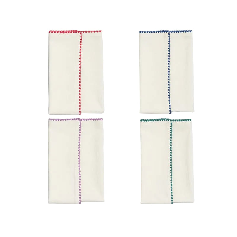 Four white napkins with colorful hem designs on a light gray background