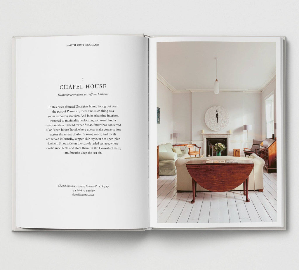 Open book showing a living room interior with a fireplace and furniture.