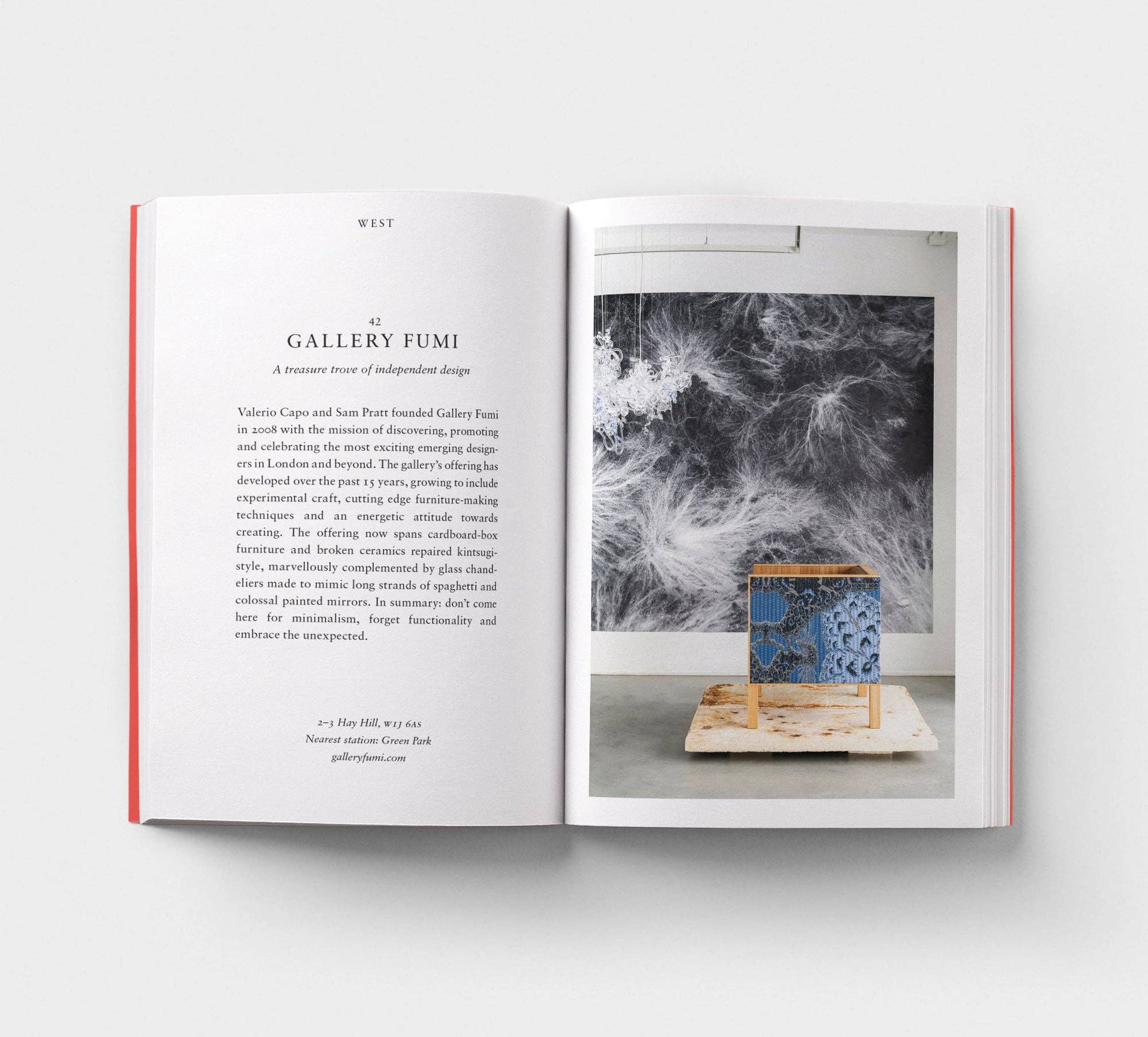 Open book with text and a photograph of a ceramic piece on a white background