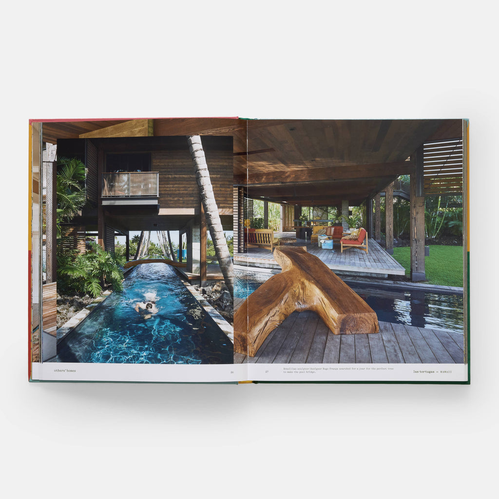 Open book showing a luxurious outdoor pool area with wooden furniture and a pool.