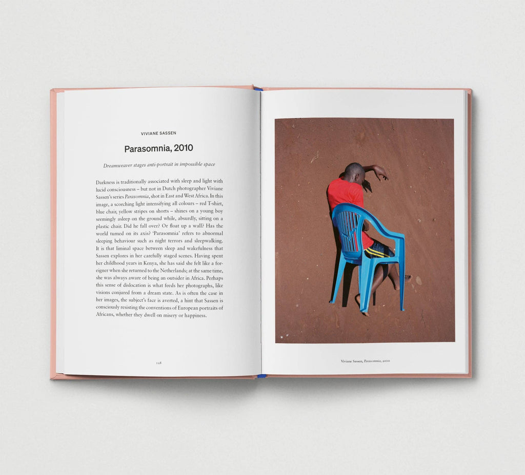 Open book with a photograph of a person sitting on a blue chair and text on a white background