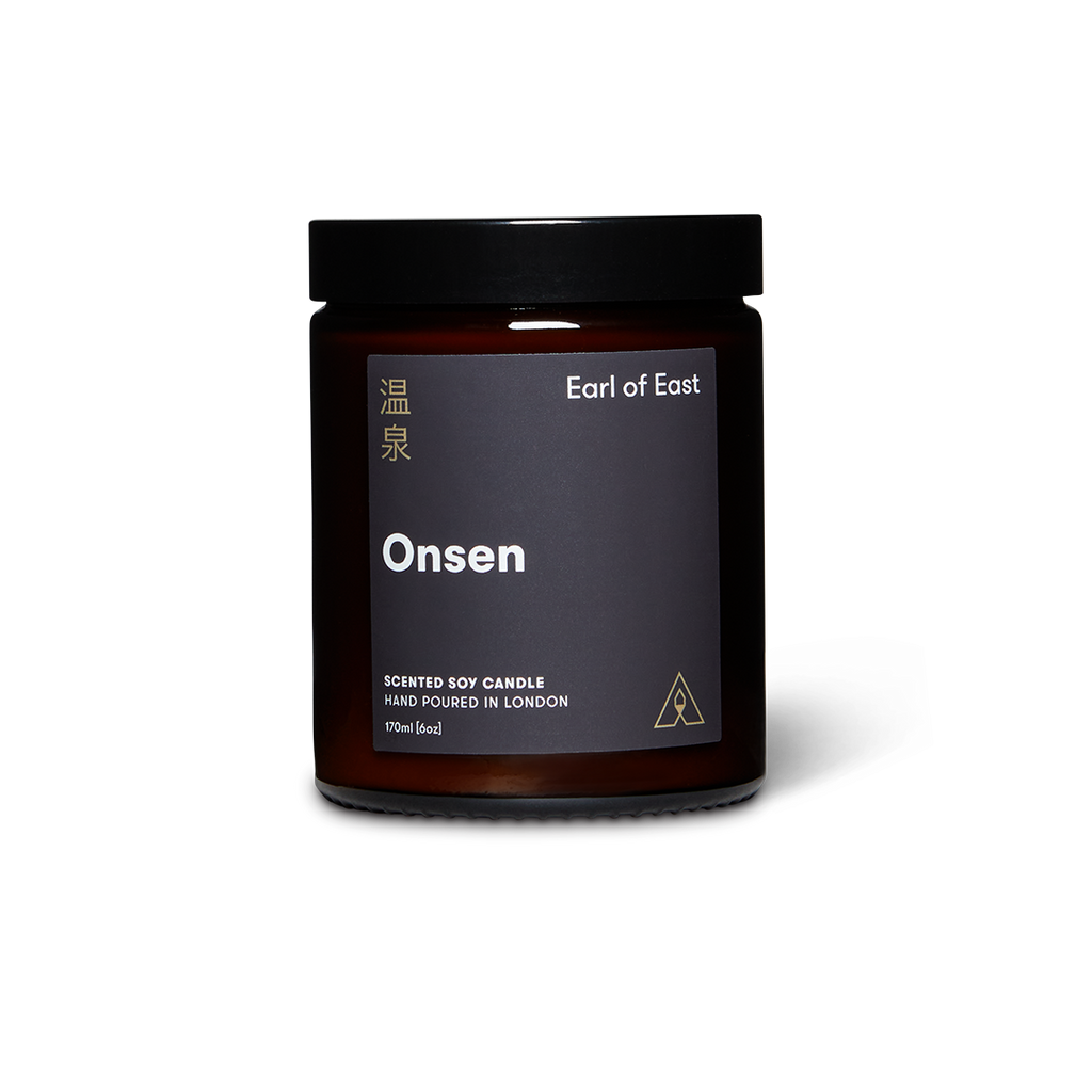 Dark brown candle jar with 'Earl of East' branding on a white background
