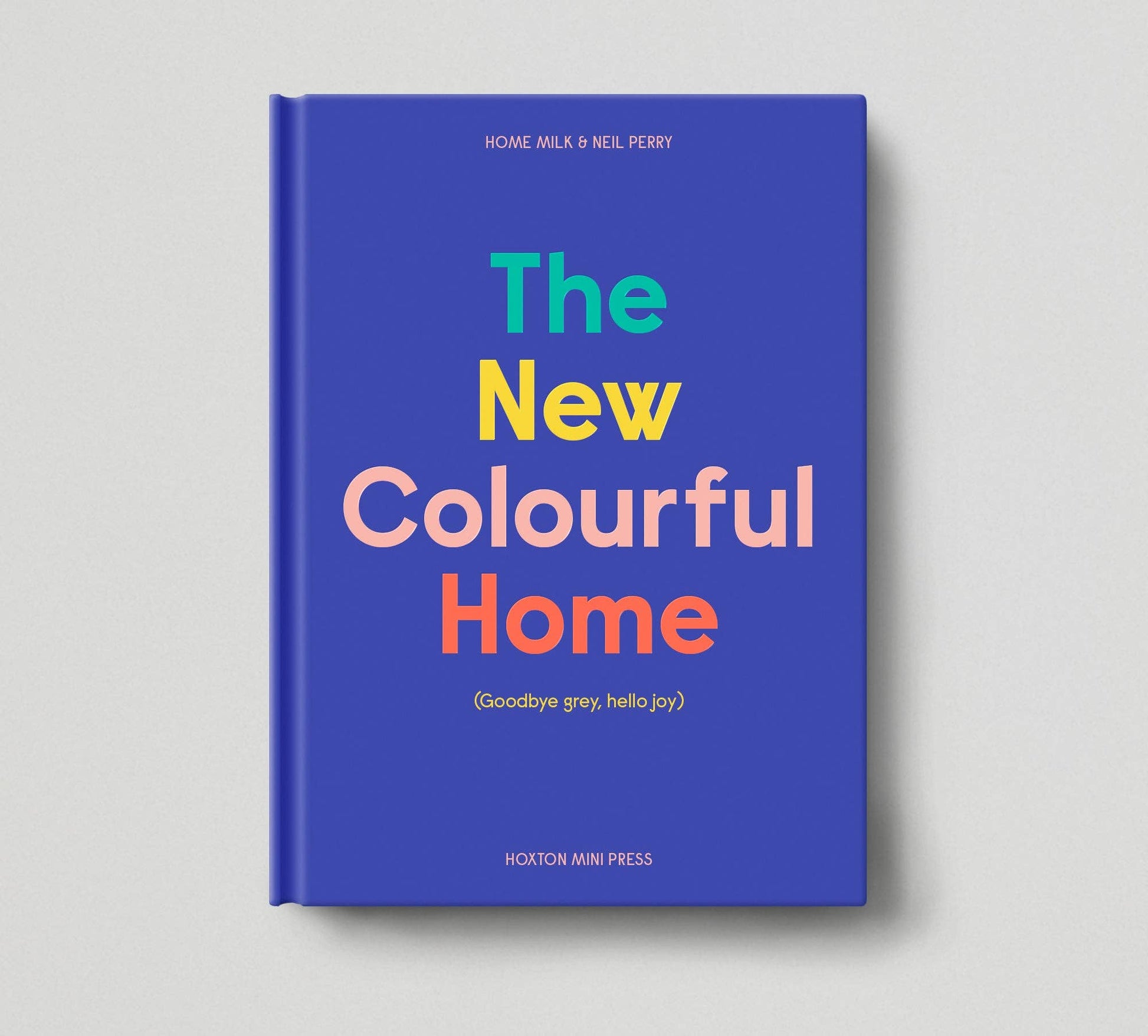 Book titled 'The New Colourful Home' with colorful text on a blue background