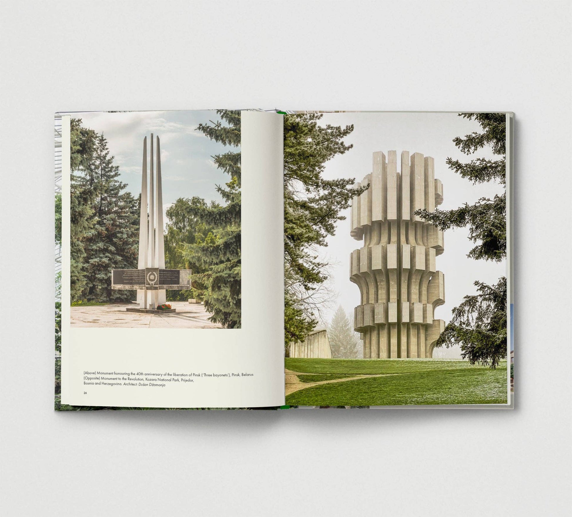 Book open to a page showing two architectural structures with trees in the background.