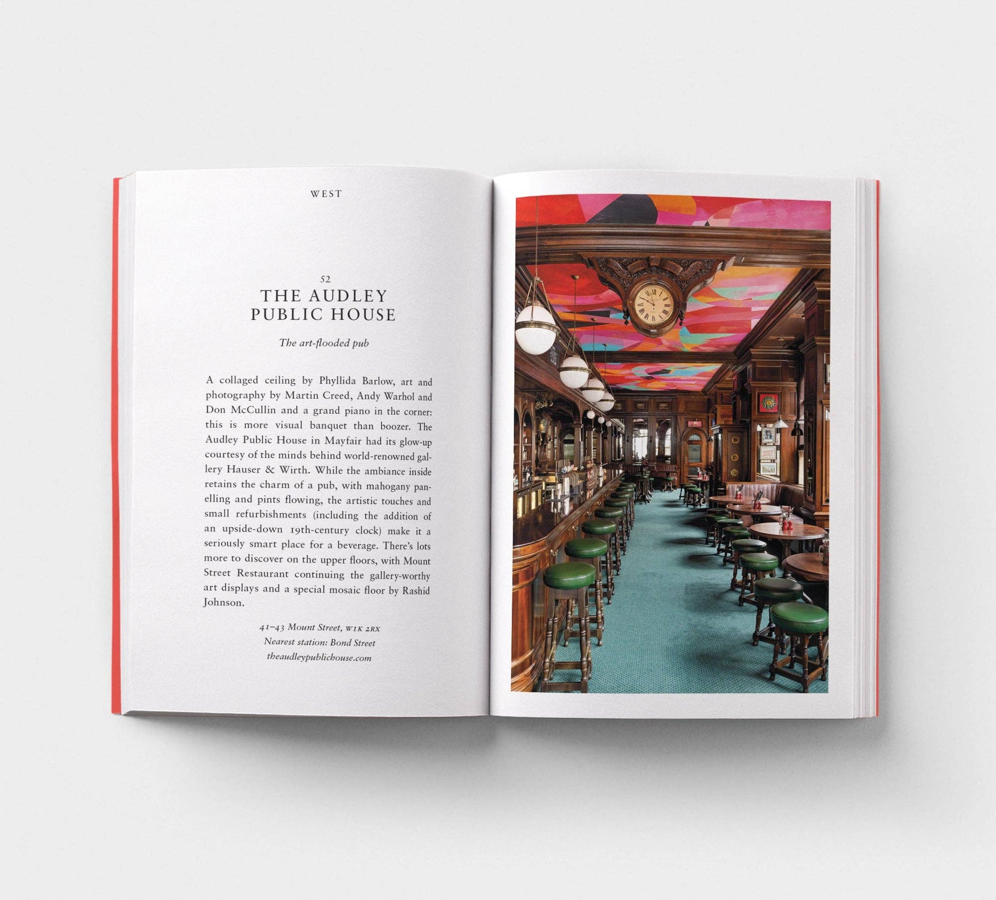 Open book showing a page with text and an interior photo of The Audley Public House.