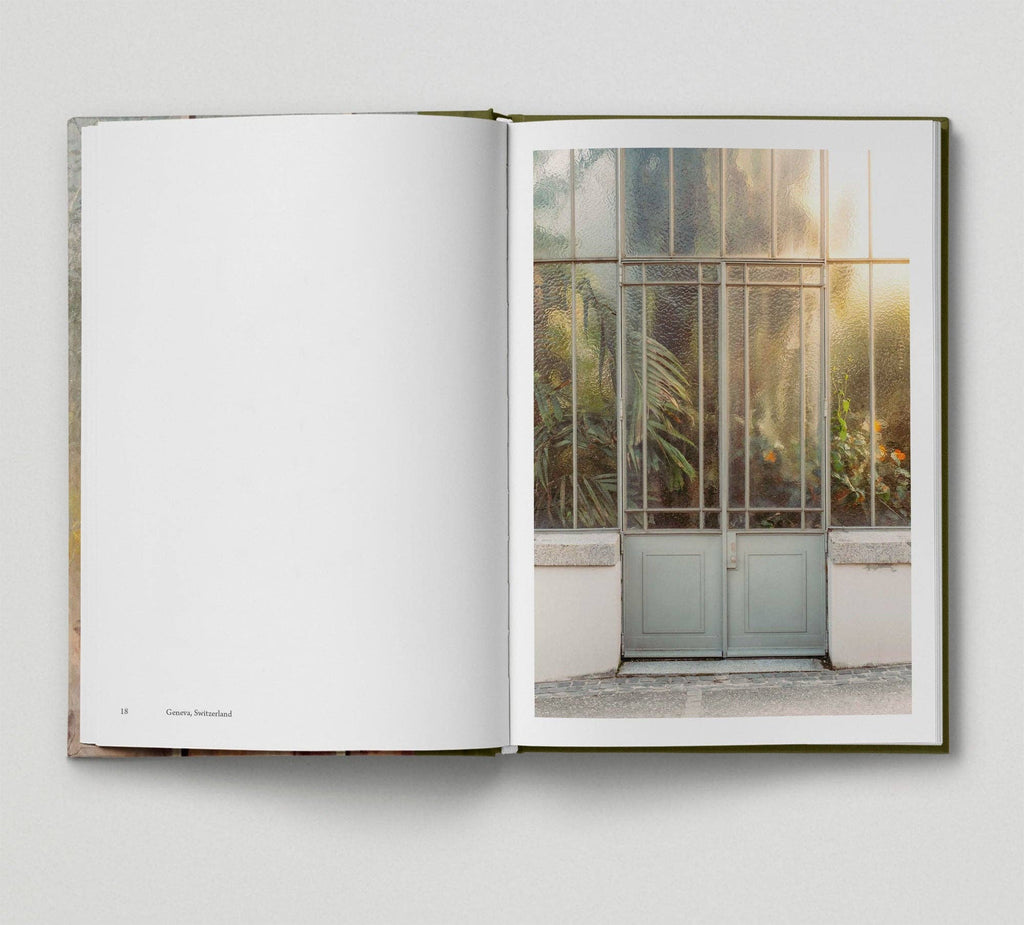 Open book showing a photograph of a glass door with sunlight filtering through