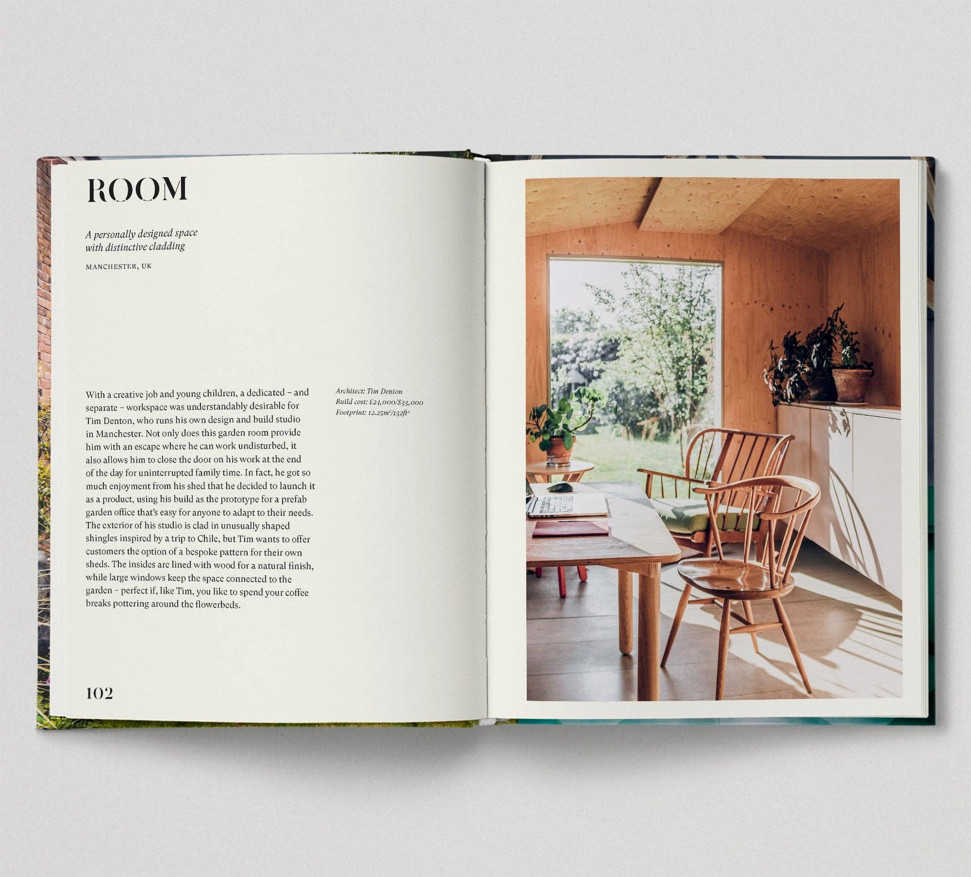 Open book showing a photograph of a room with wooden furniture and a window.