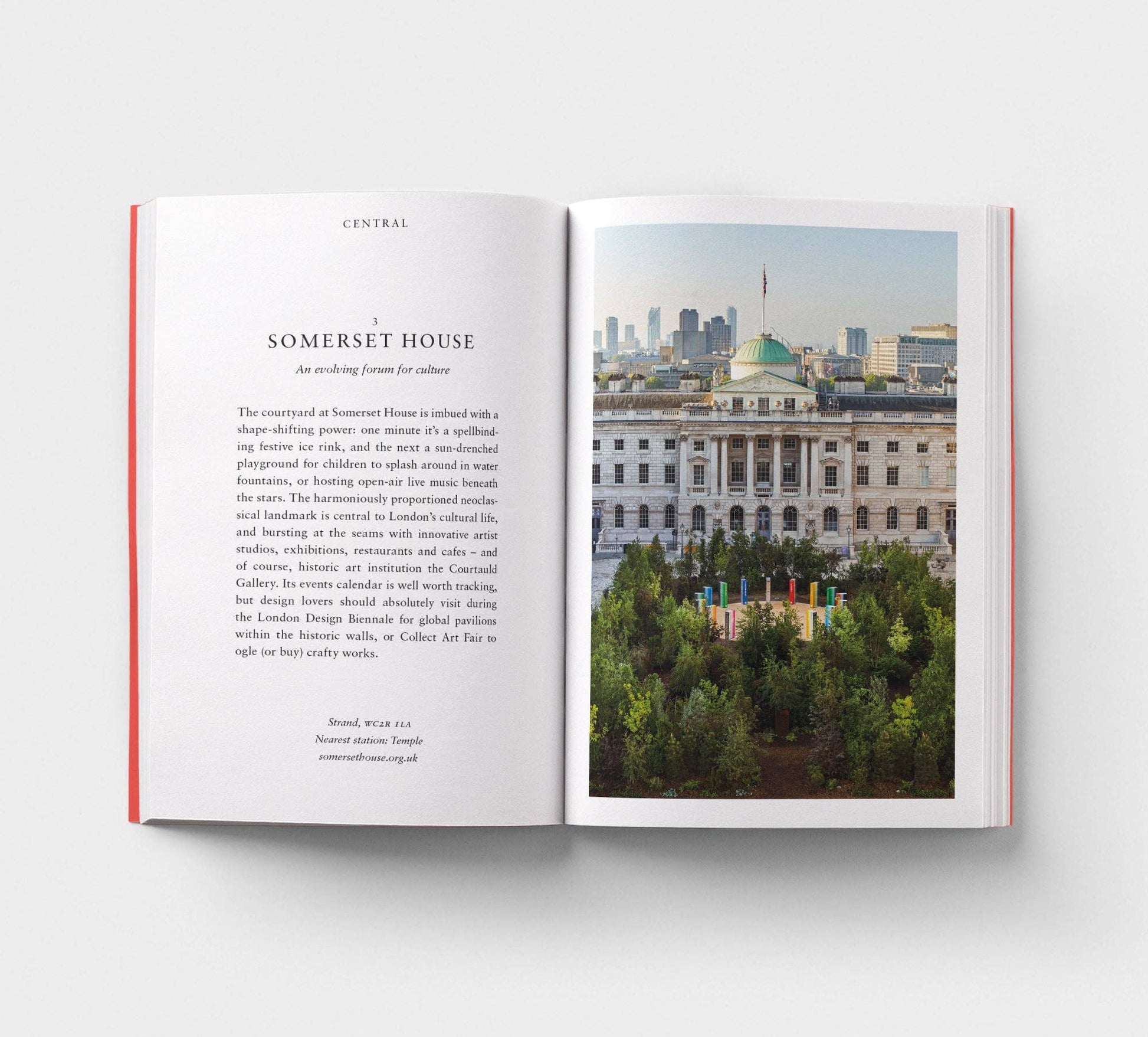 Open book with text and a photograph of a building on a white background