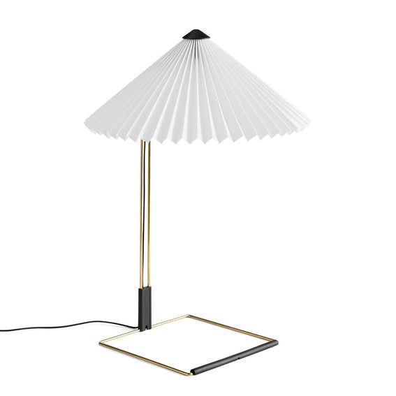 Table lamp with a white pleated shade on a white background