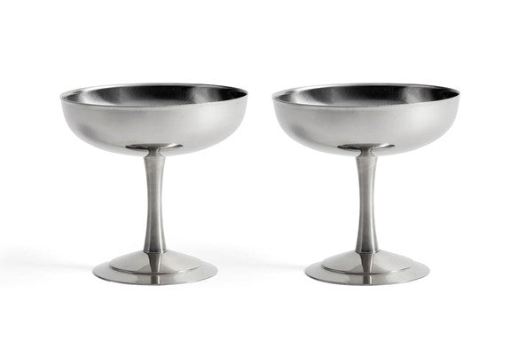 Two polished silver champagne coupe glasses with stemmed bases, shown side by side on a white background.