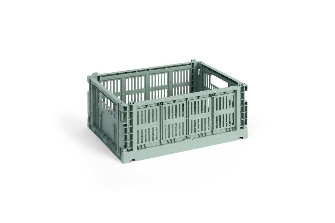 Green plastic crate on a white background