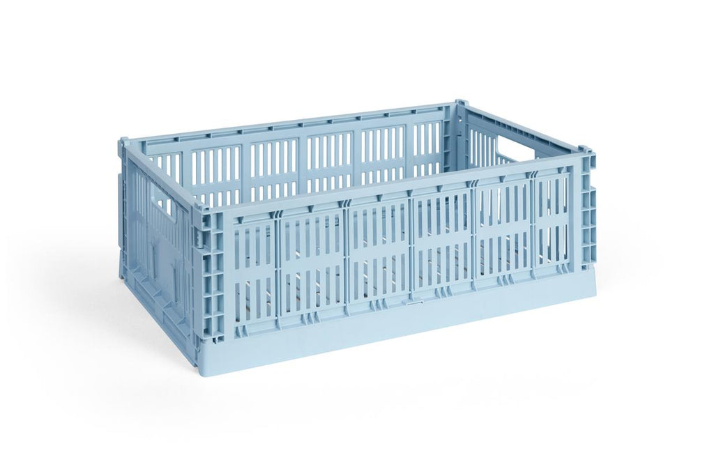 Light blue plastic crate on a white background