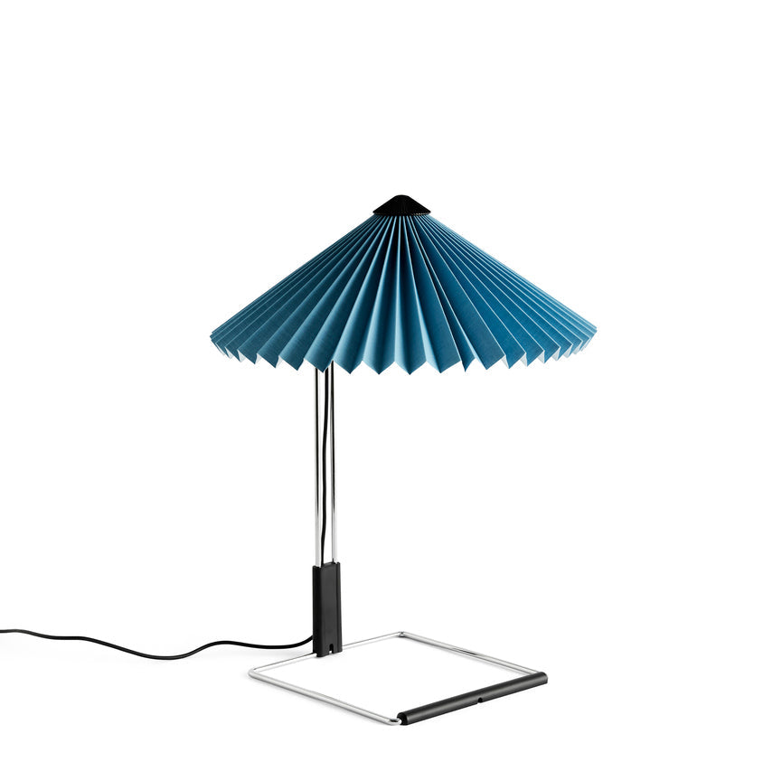 Blue pleated table lamp on a white background