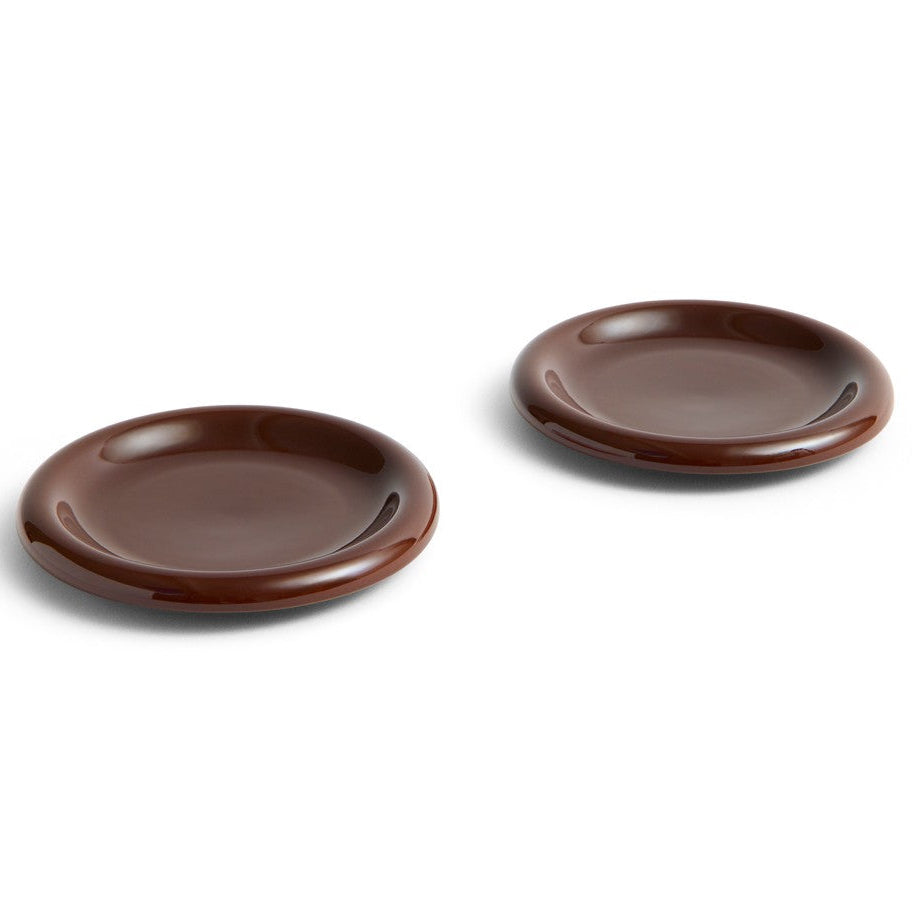 Two brown ceramic plates on a white background