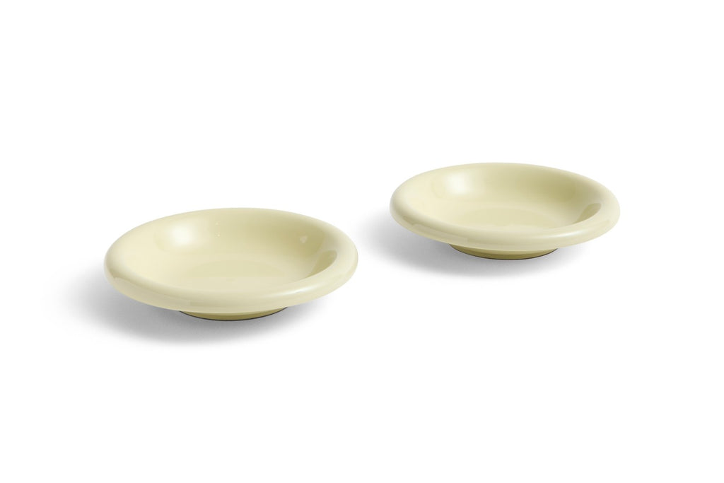 Two beige ceramic bowls on a white background