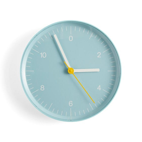 Light blue wall clock on white background