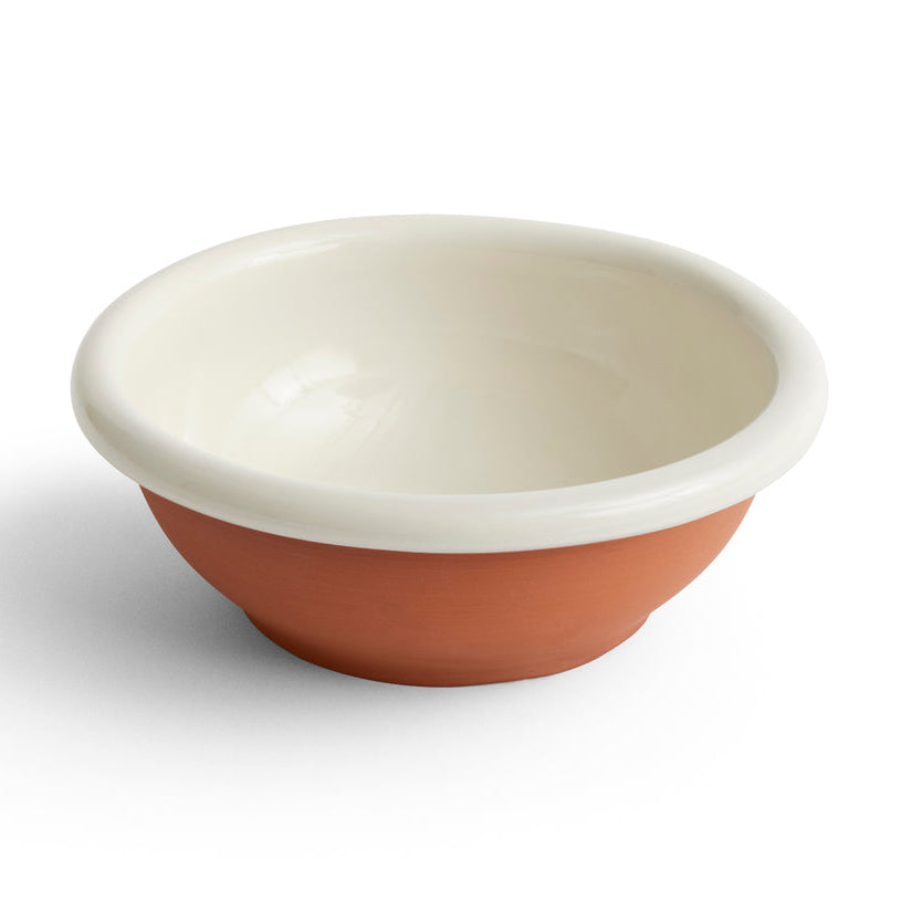 A small ceramic bowl with a warm terracotta orange-brown exterior and a glossy cream-white interior, shown on a clean white background.