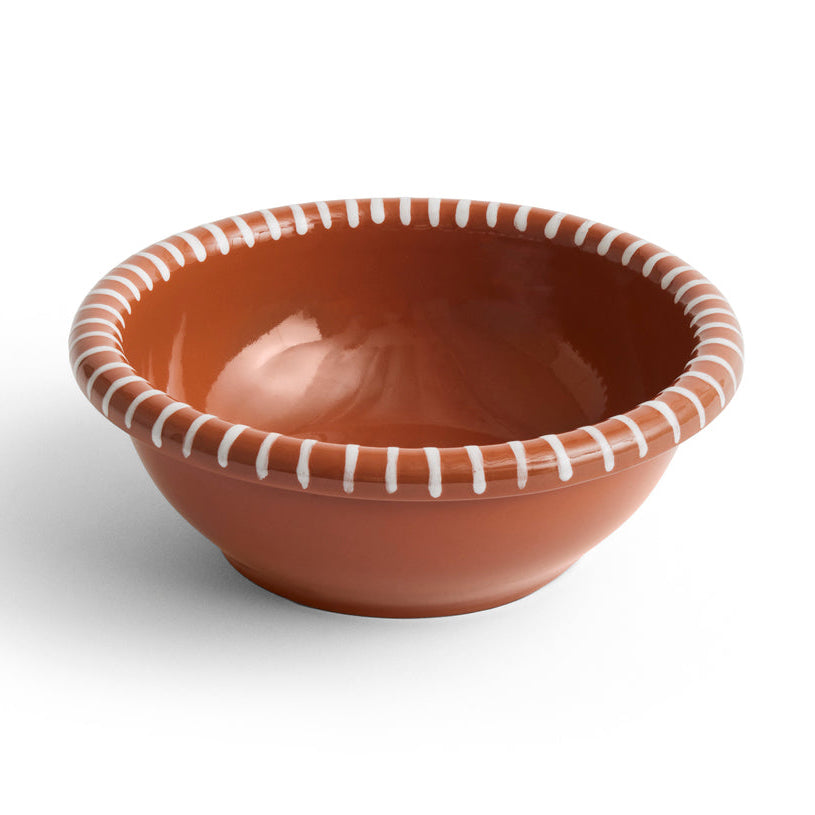 Ceramic bowl with brown glaze and white decorative rim on a white background