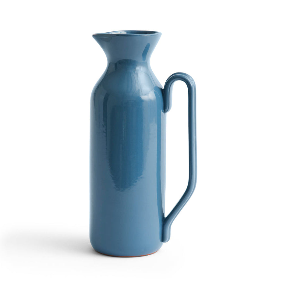 Blue ceramic pitcher on a white background