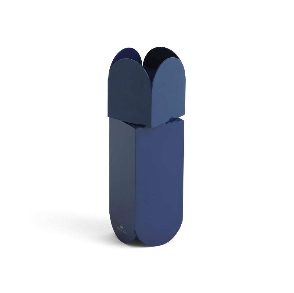 A modern capsule-shaped portable power bank in a deep navy blue color, shown standing upright on a clean white background.