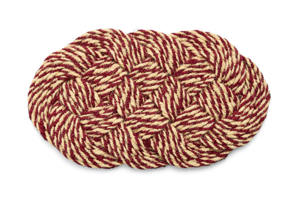 Woven braided mat with red and beige pattern on a white background