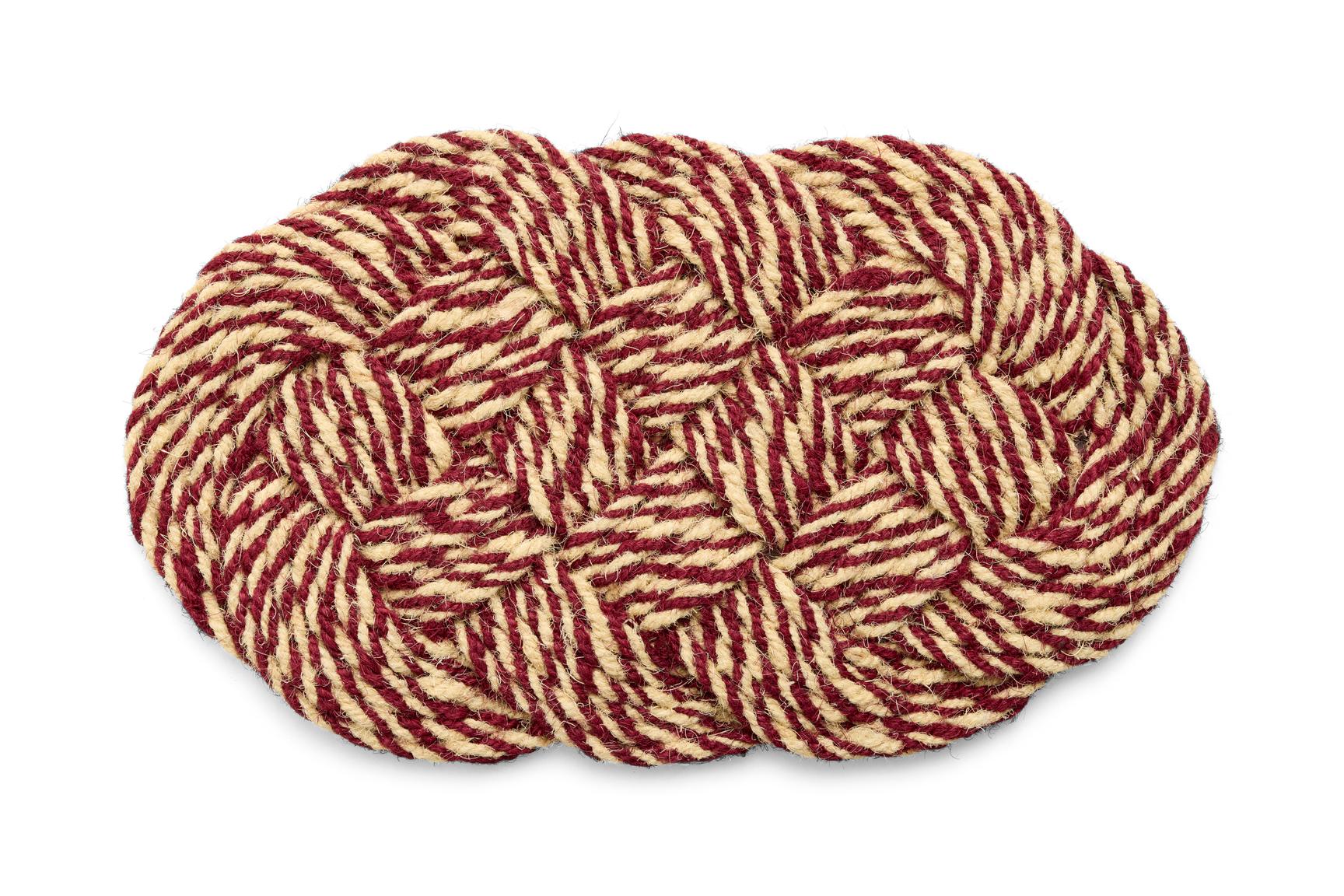 Woven braided mat with red and beige pattern on a white background