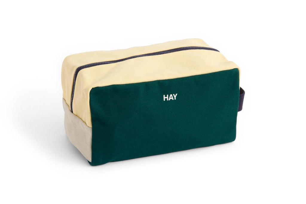 Green and beige toiletry bag with 'HAY' branding on a white background