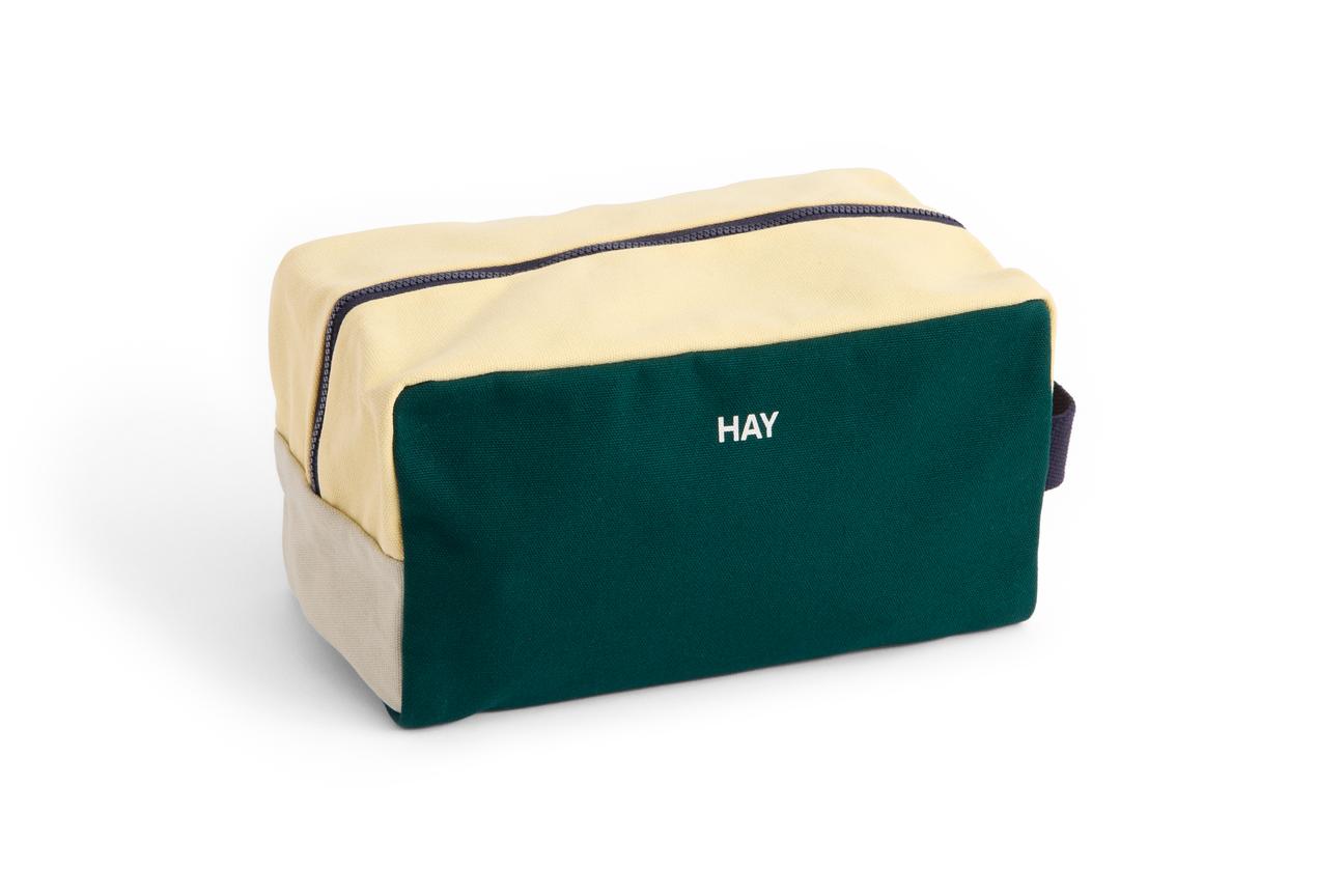 Green and beige toiletry bag with 'HAY' branding on a white background